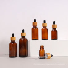 Frosted custom cosmetic skin care glass dropper bottle 5ml 10ml 15ml 20ml 30 ml 50ml 100ml with bamboo lid for essential oil